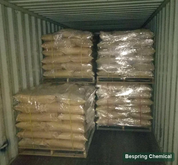 Wrapped paper bags stacked on pallets inside a shipping container