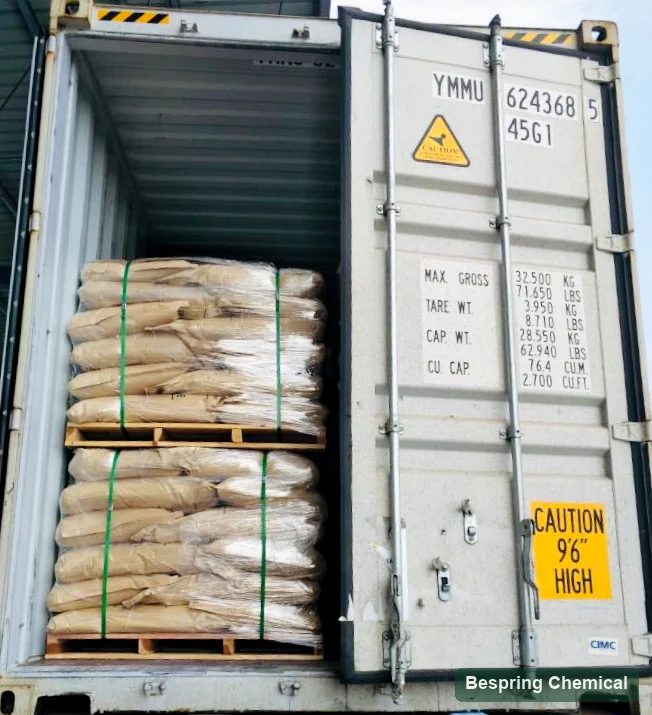 Wrapped paper bags on pallets inside an open shipping container