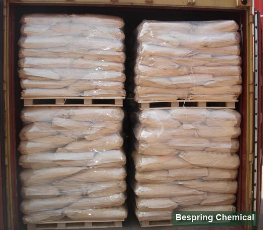 Wrapped paper bags stacked on four pallets inside an open container