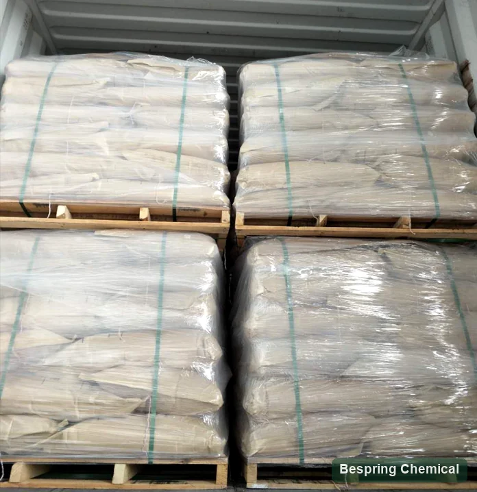 Wrapped paper bags stacked on four pallets inside a container